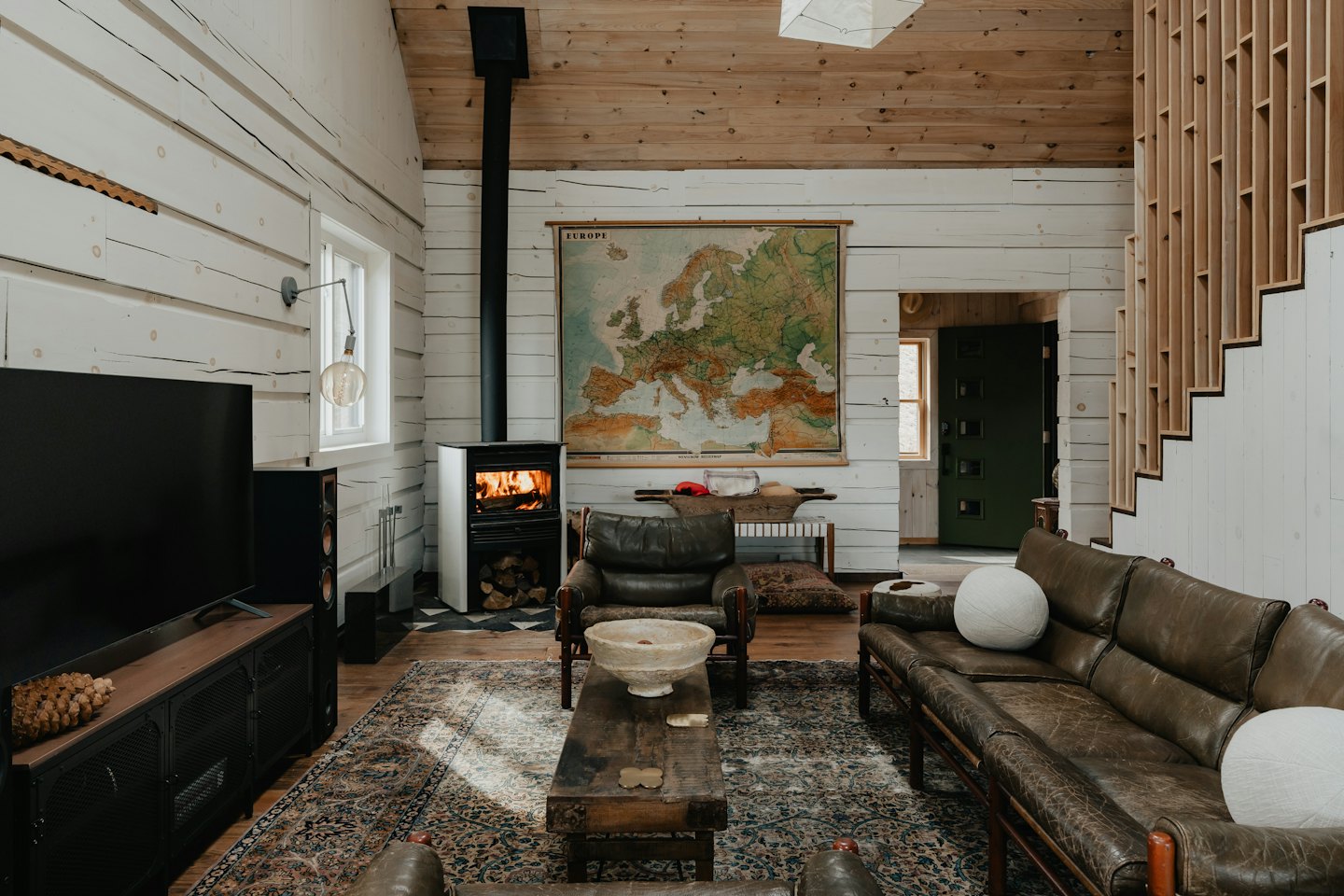 Cozy living room with fireplace and leather furniture.